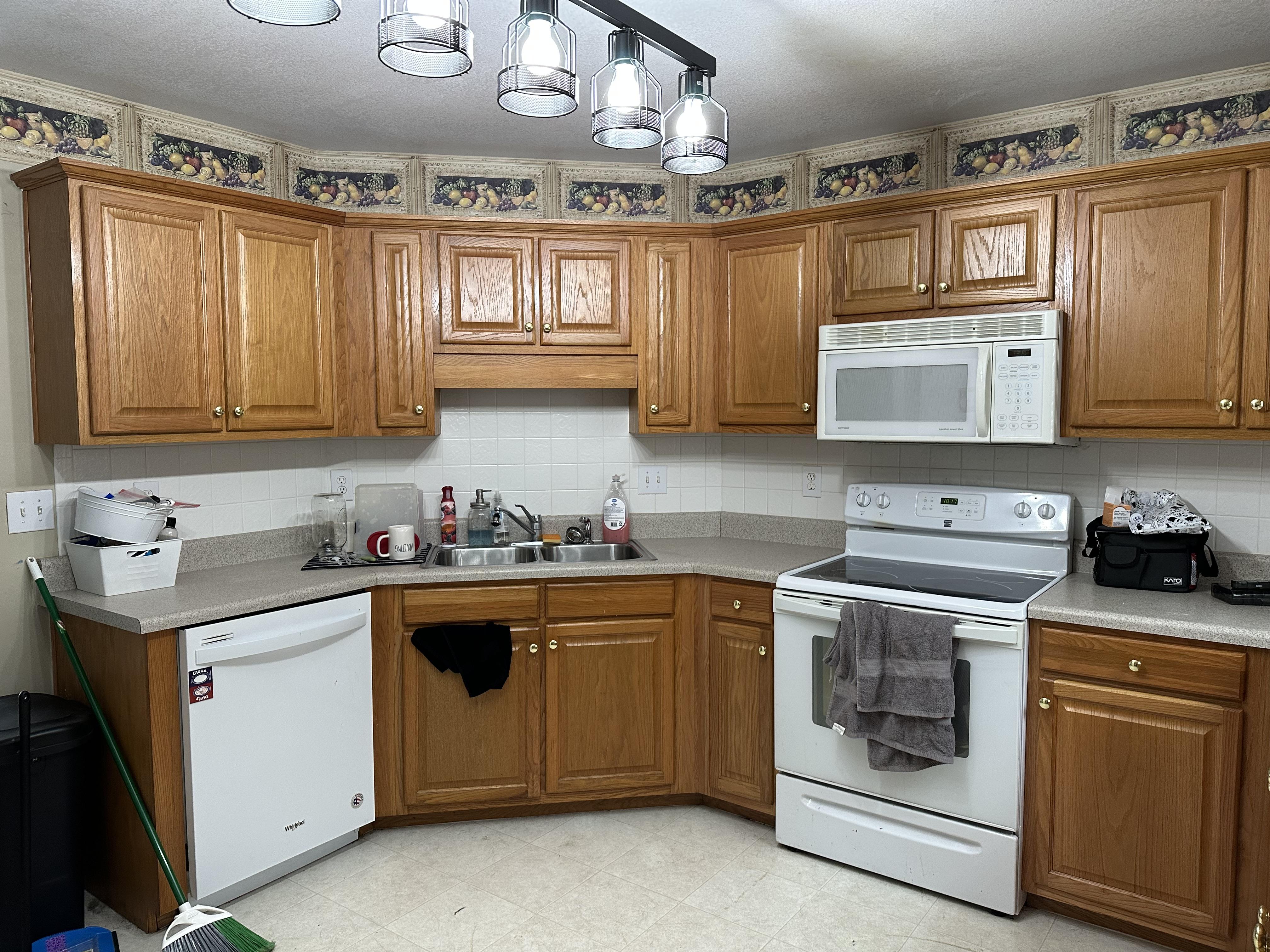 We Buy Houses Cash in Bonaire GA. Older kitchen with a broken stove and missing flooring..JPG