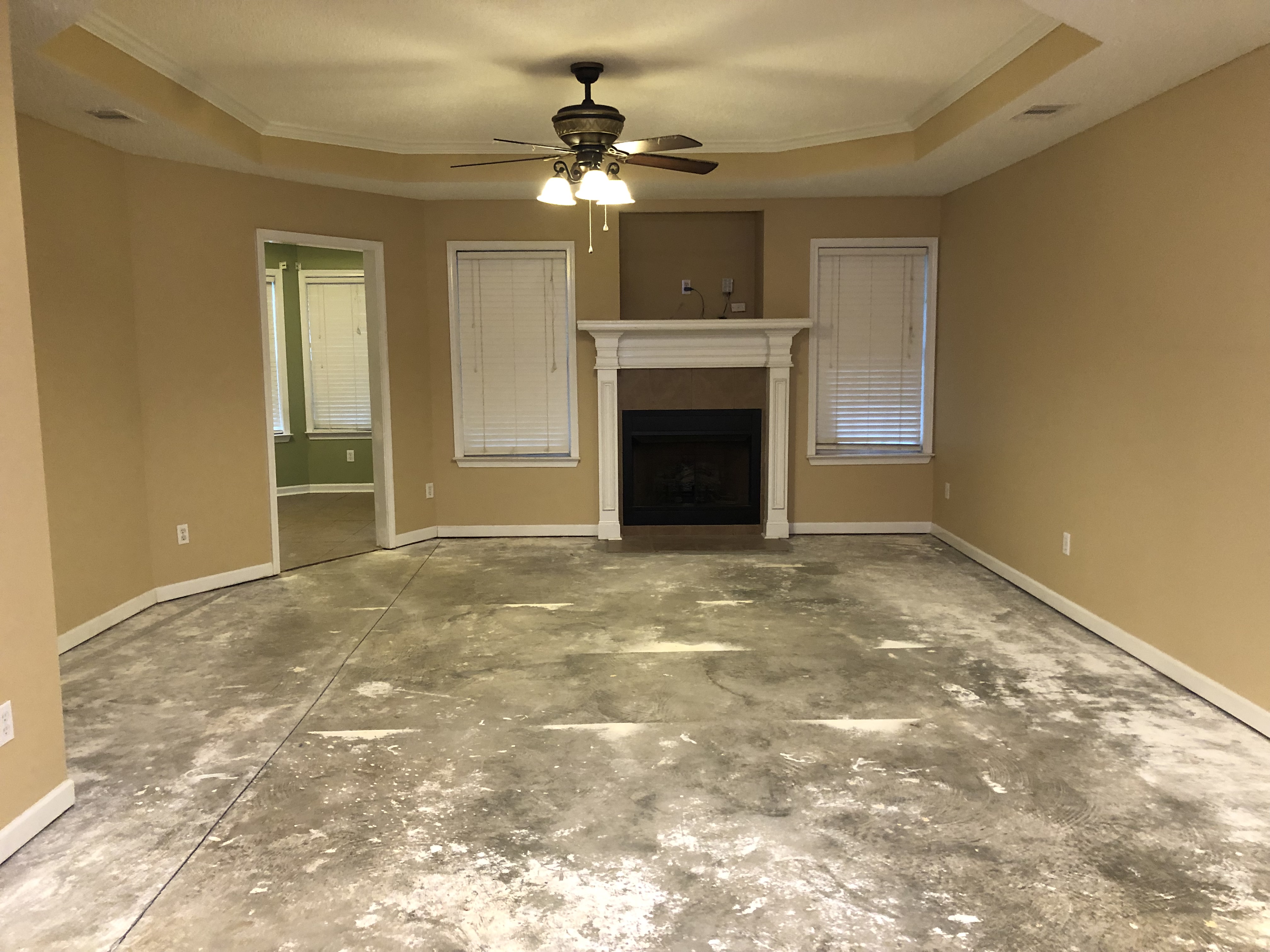 Sell my house cash in Bonaire GA. Living room with no flooring and missing trim because of pet damage and job change.JPG