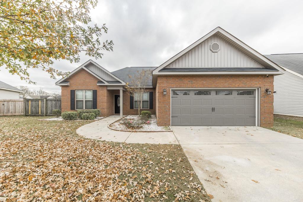 We Buy Houses in Byron GA. Brick Front Home with leaves on the ground.