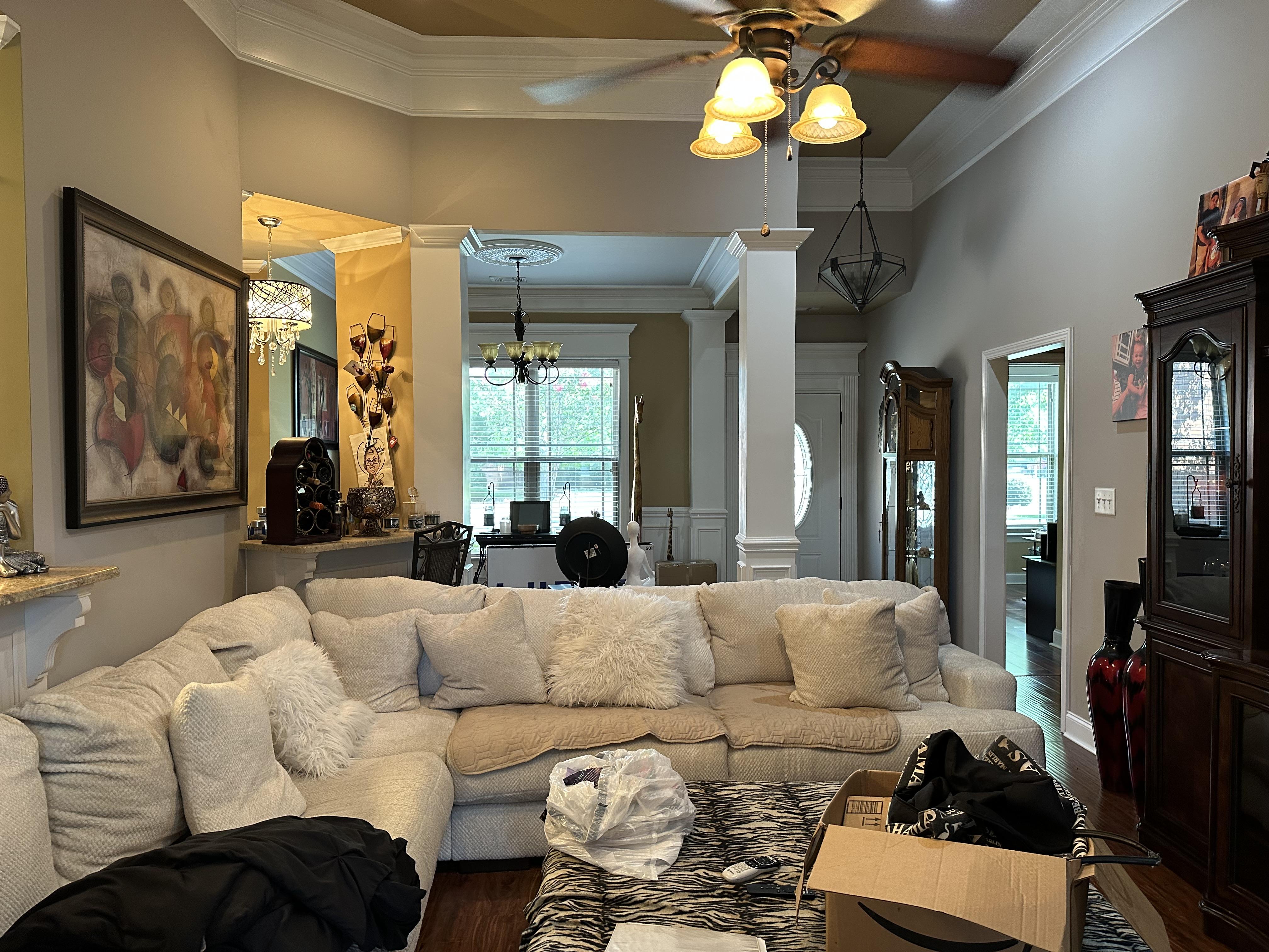 We Buy Houses Cash in Byron GA. Cluttered living room that needs updating and a guaranteed sale date.