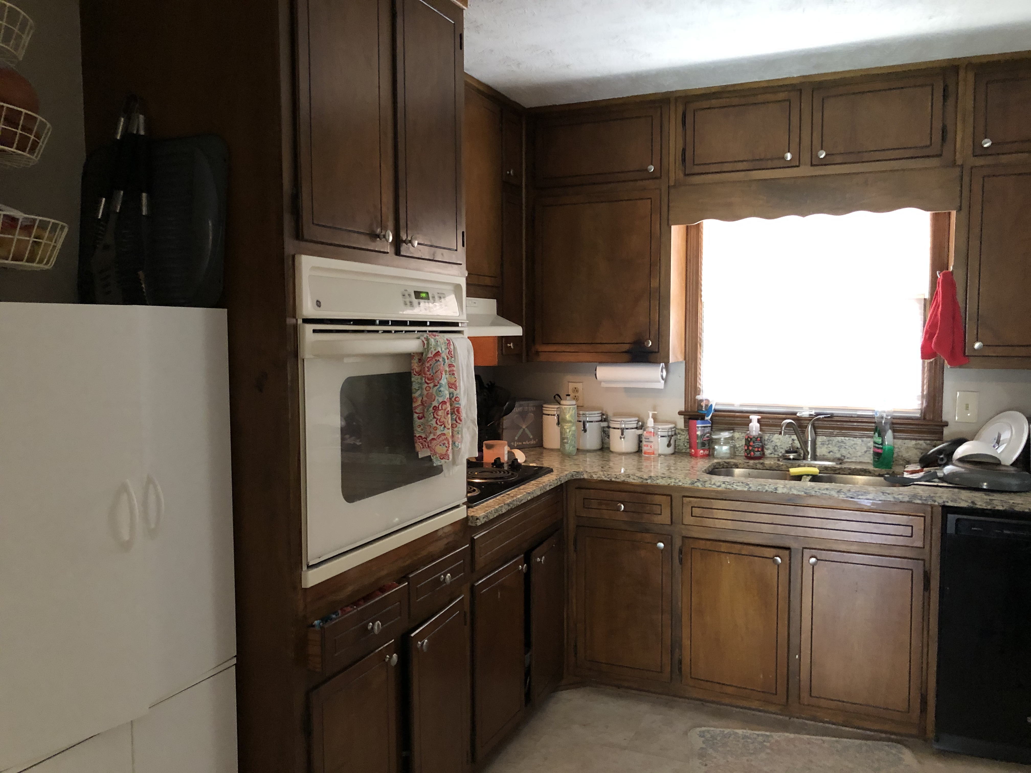 We Buy Houses fast in Lilburn GA. Old wood cabinet kitchen with mismatch appliances.