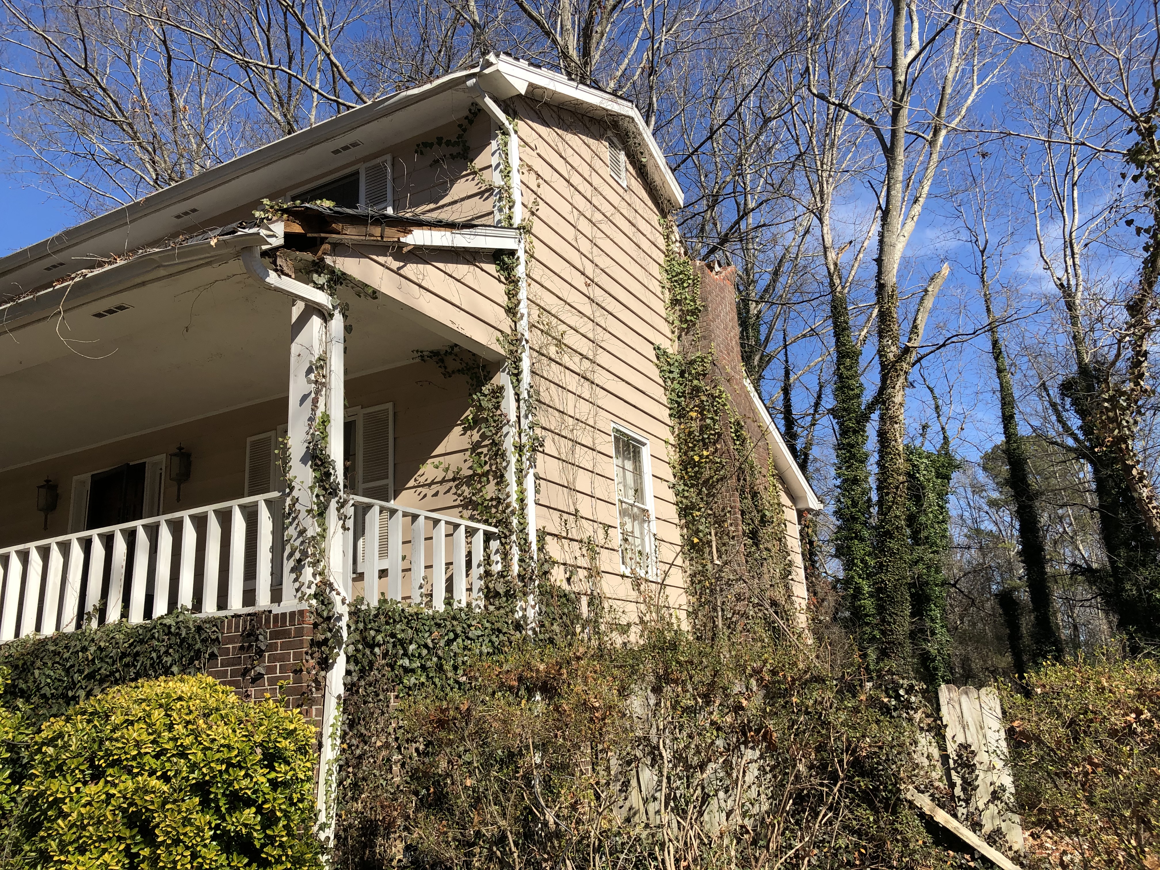Sell my house cash in Lilburn GA. Side of the house is falling apart and covered in ivy.