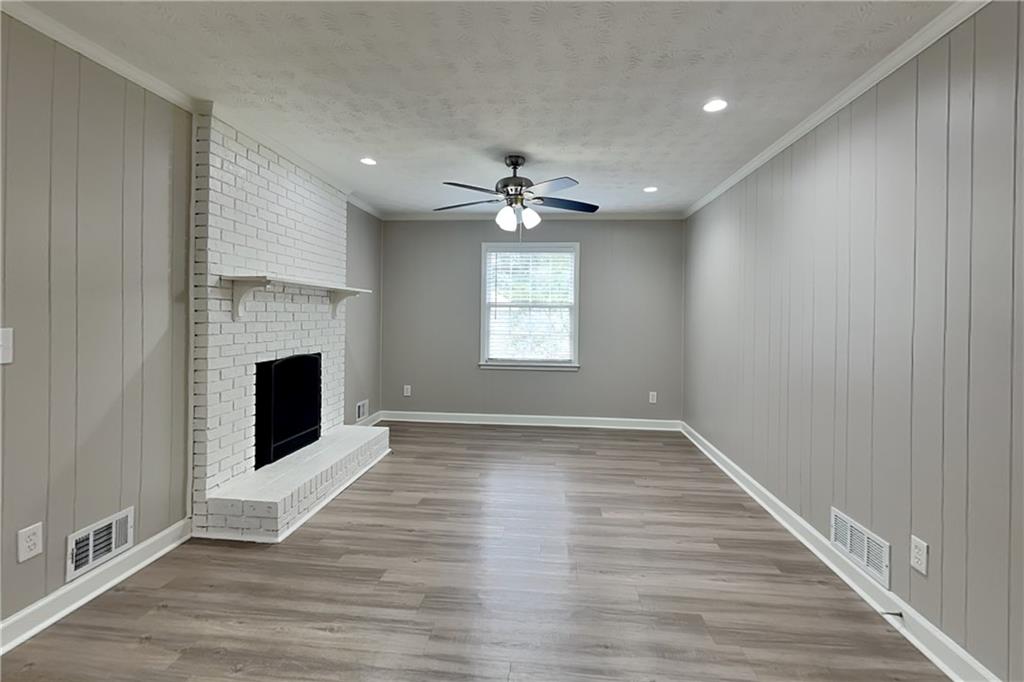 We buy houses in Snellville GA fast and as is. Renovated family room with new flooring and painted fireplace.