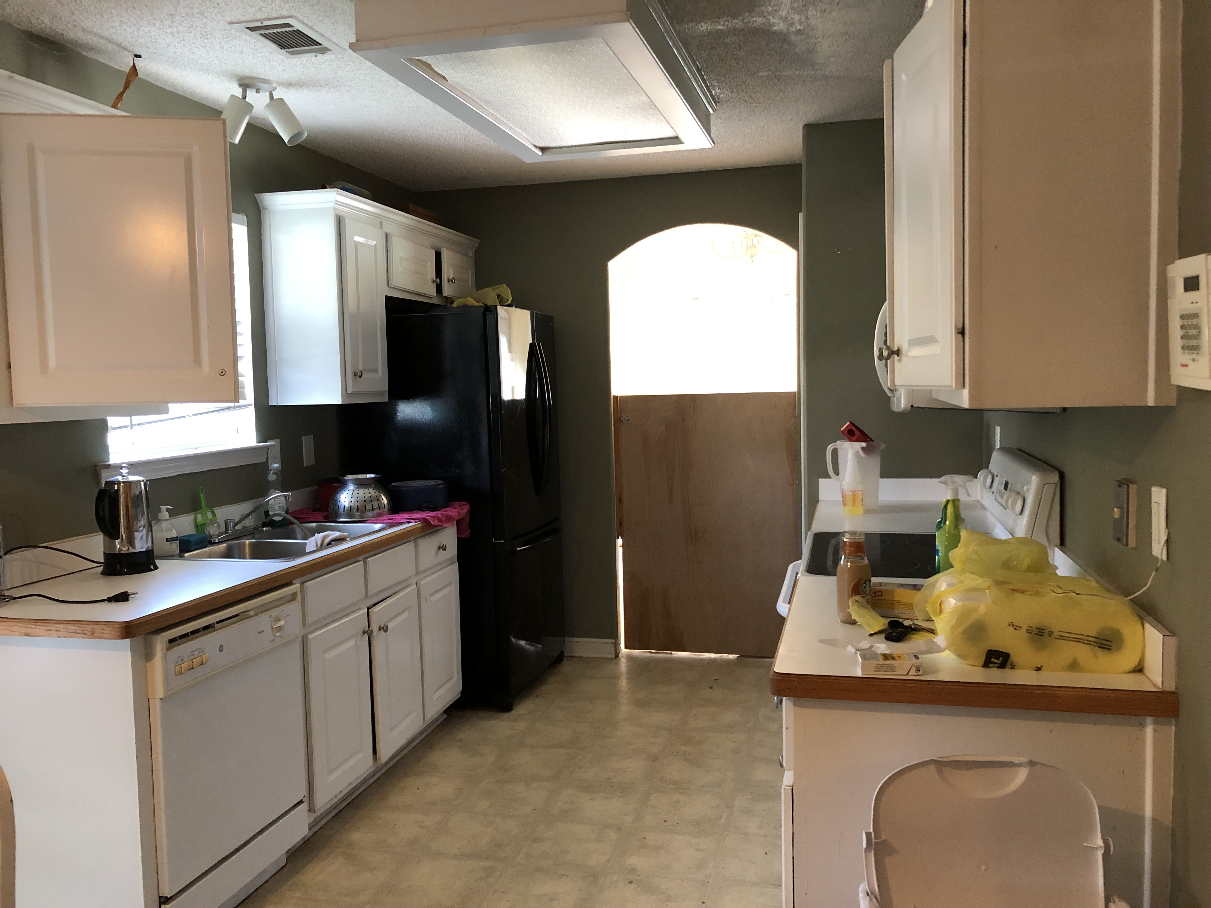 Sell my house cash in Snellville GA. Dirty kitchen with leaks in ceiling and broken cabinets.