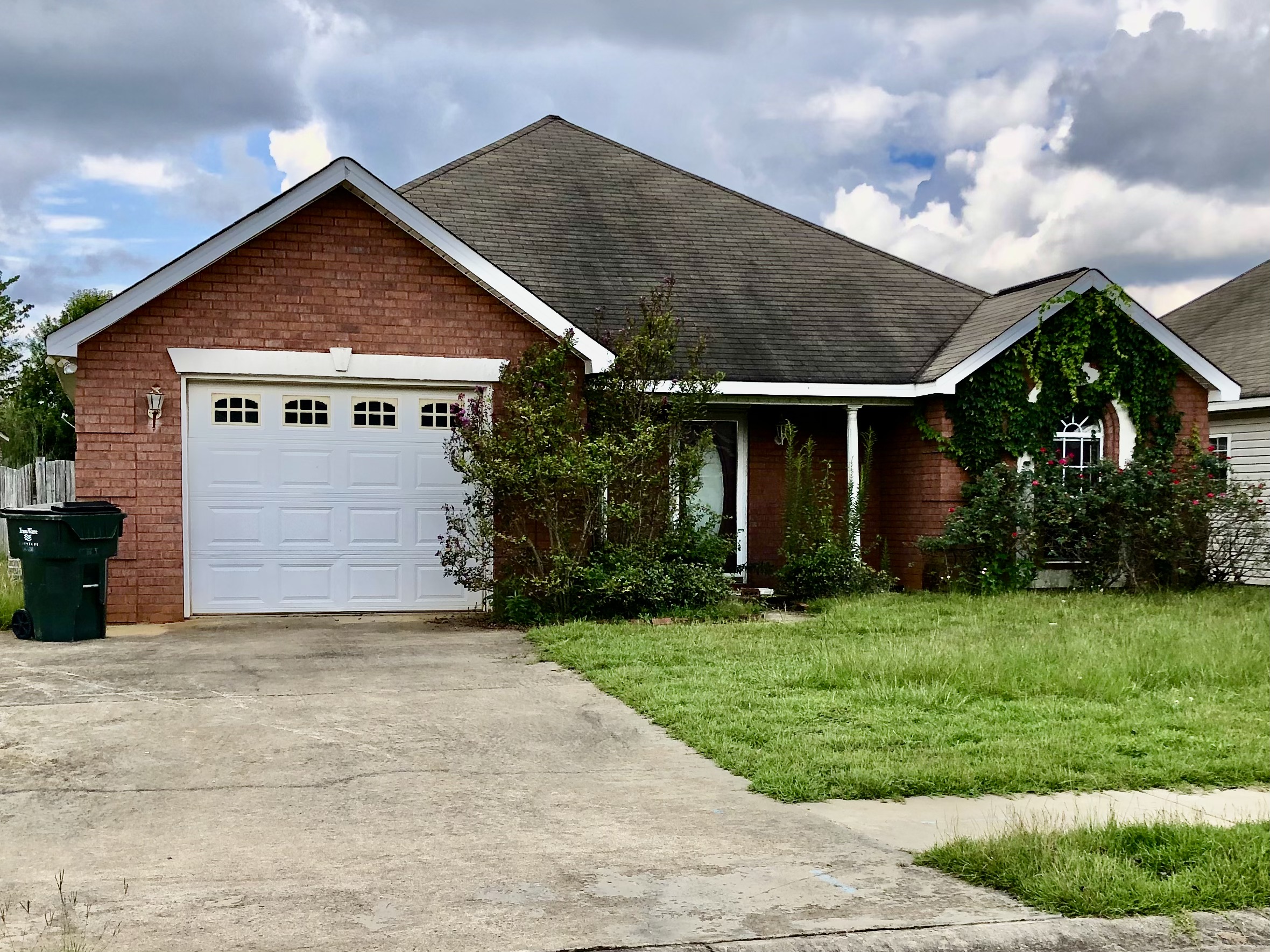 Sell my vacant house, inherited house. Brick front overgrown with ivy and termite damage.