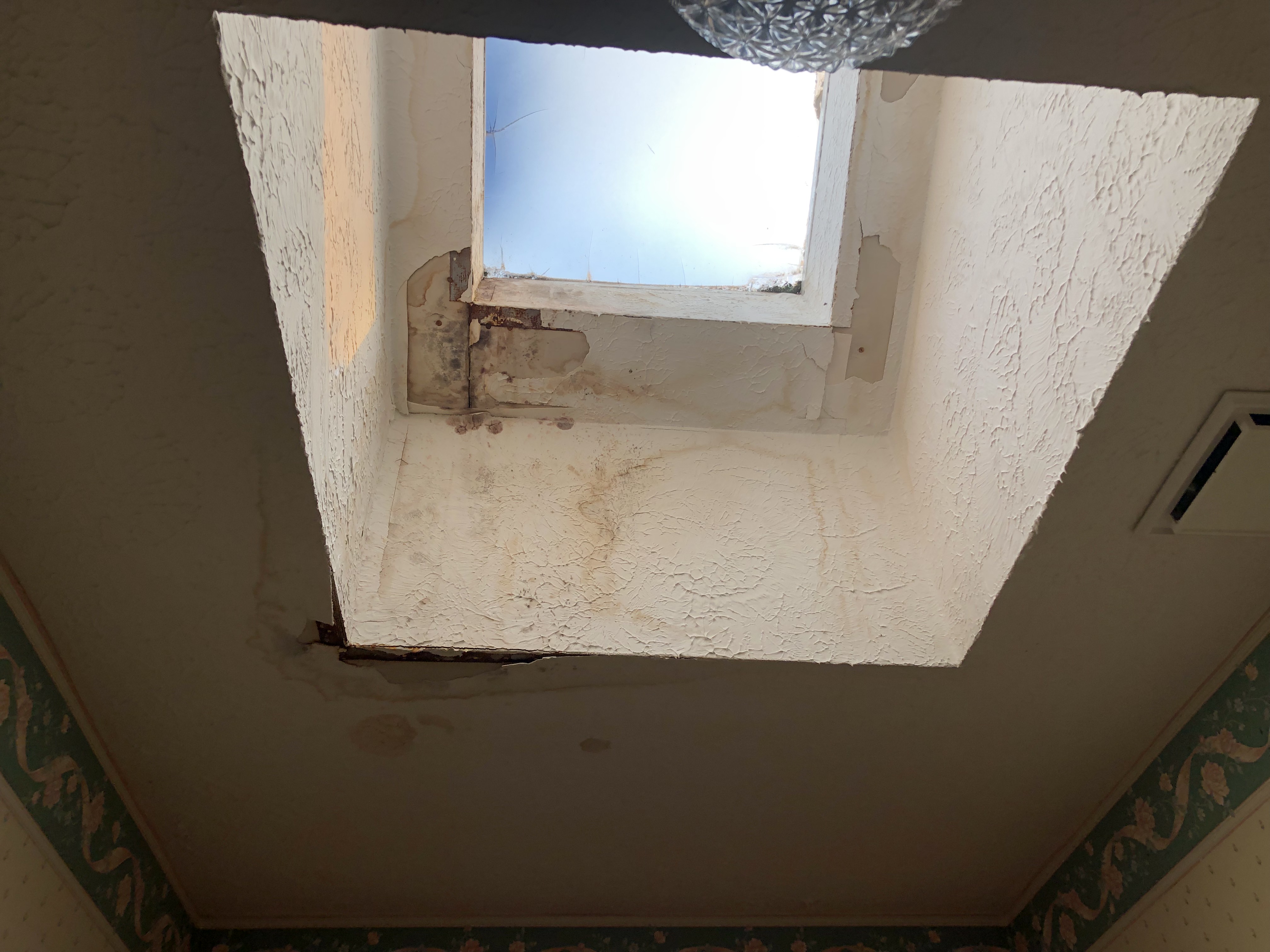 Water damage in a vacant house. Sunroof leak that is ruining drywall, studs and flooring.