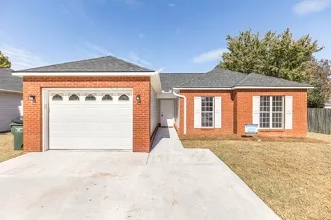We buy houses fast like this brick ranch with one car garage.