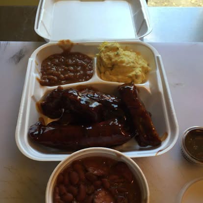 Photorealistic platter of crispy chicken wings tossed in a sticky hot sauce with a small cup of blue cheese dip.