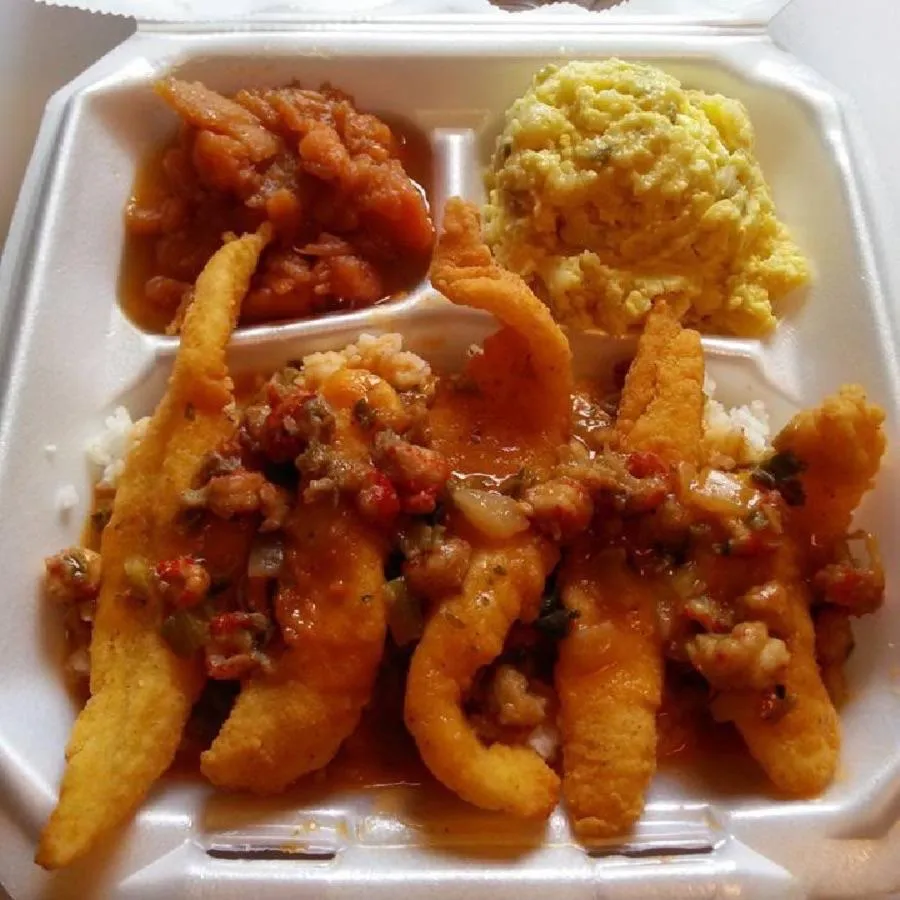 A plate of lemon snowball desserts dusted with powdered sugar, garnished with mint and seasonal fruit.