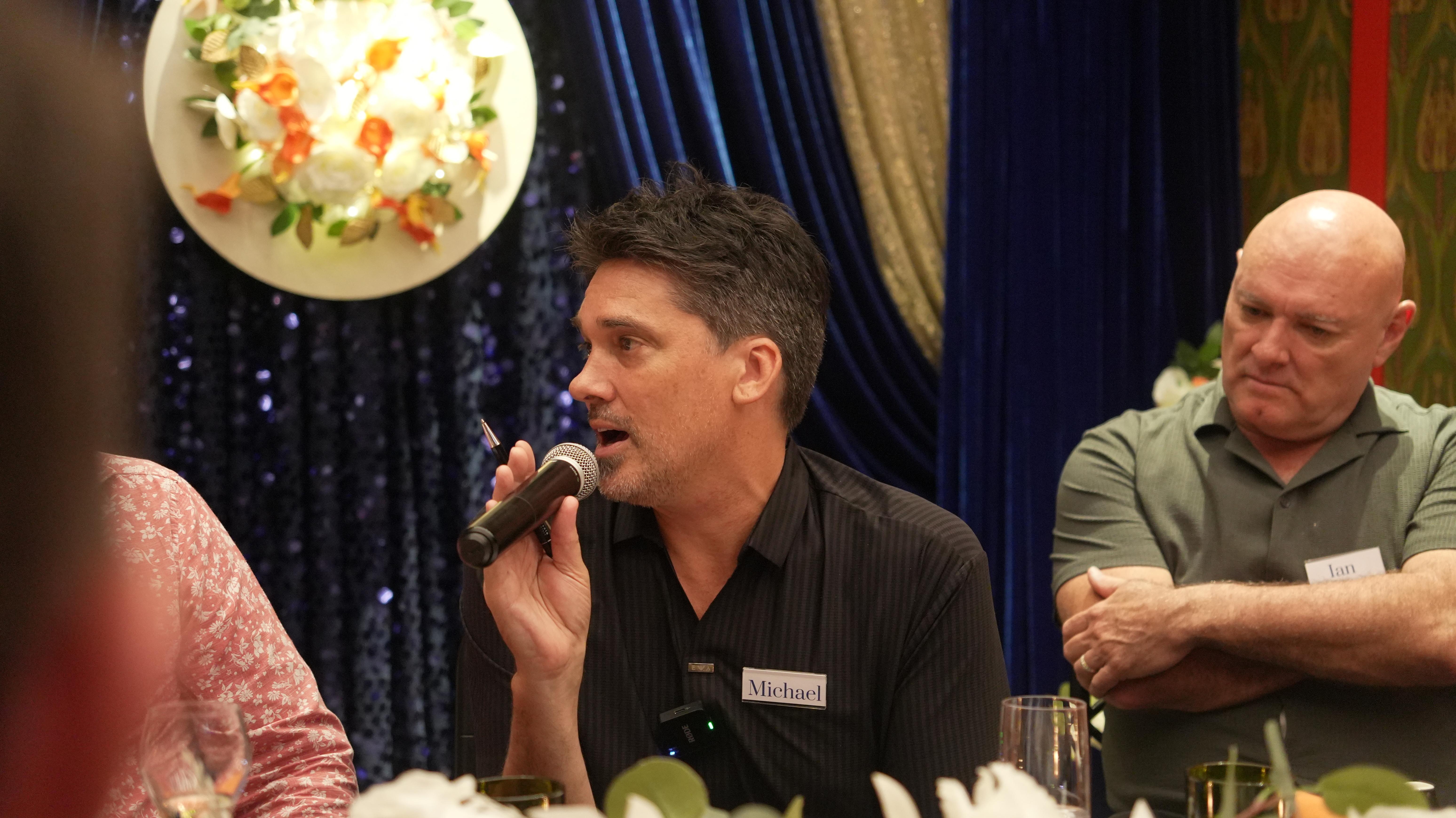 Speaker presenting on stage to an audience