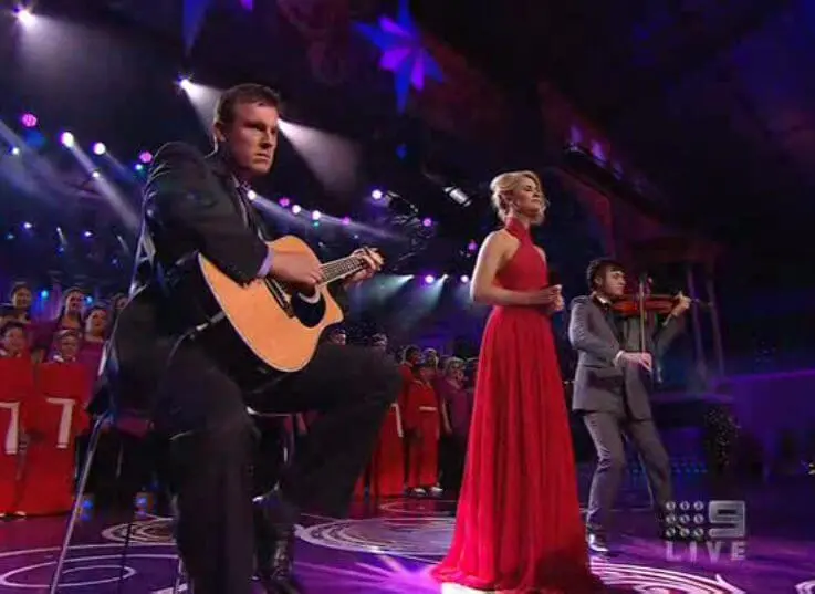 man in blue denim top standing under tree leaf