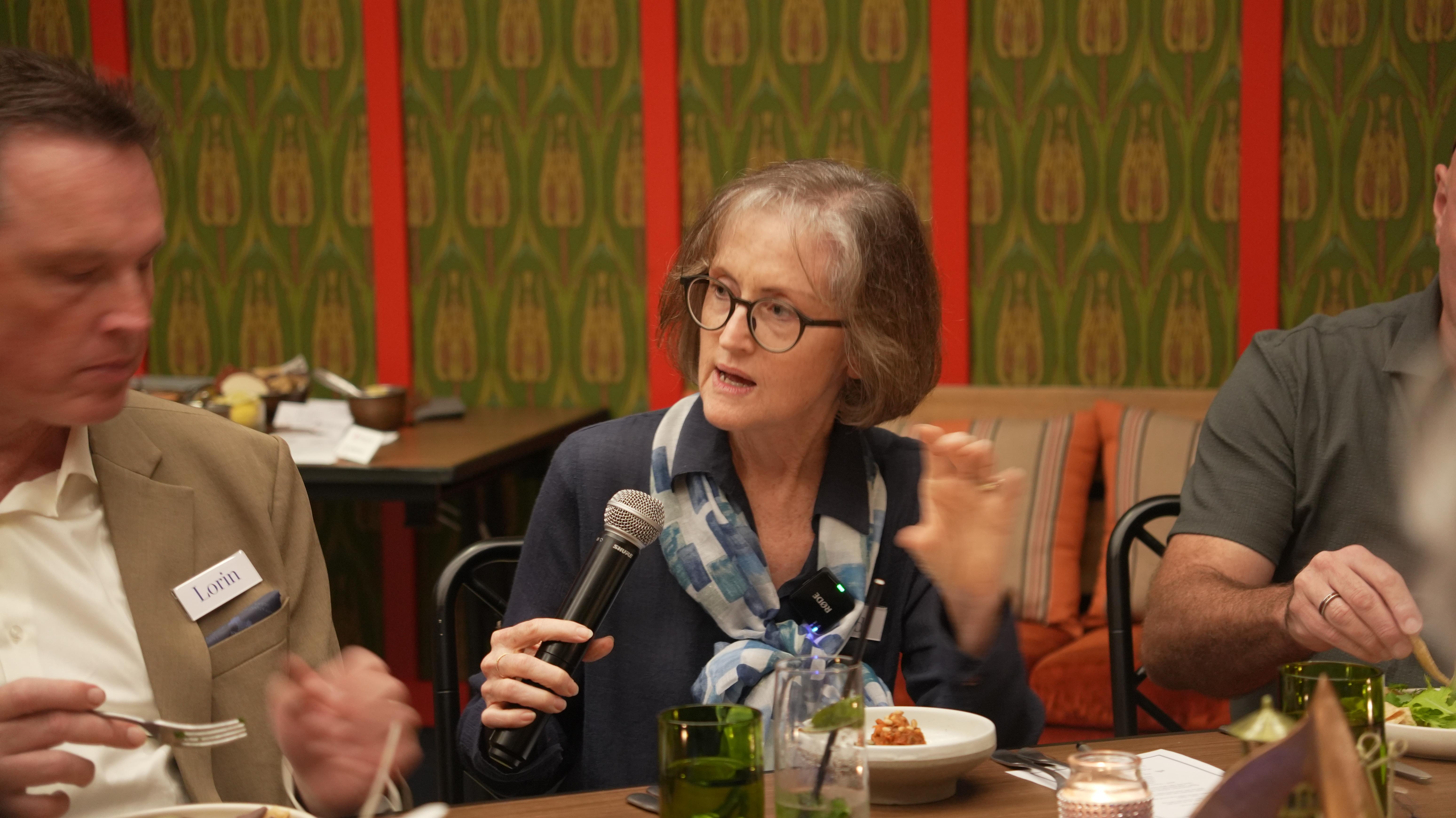 man in blue denim top standing under tree leaf