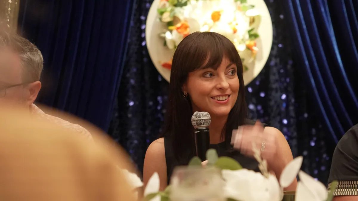 man in blue denim top standing under tree leaf
