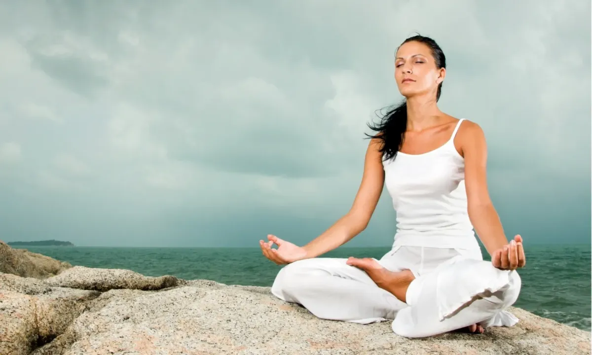 Woman meditating with the help of Lotus Journey's powerful guided meditations.