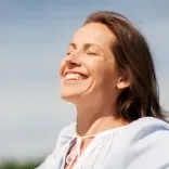 Woman finding peace following a Quantum Regression and Integration Therapy session.