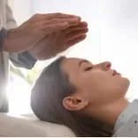 Practitioner performing Hypnotherapy and Quantum Regression to a client in a Q-RIT session.