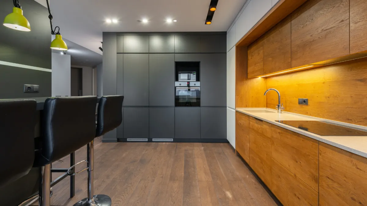 Austin Precision Kitchen & Bath Remodel team designing an open-concept kitchen with elegant lighting and island seating