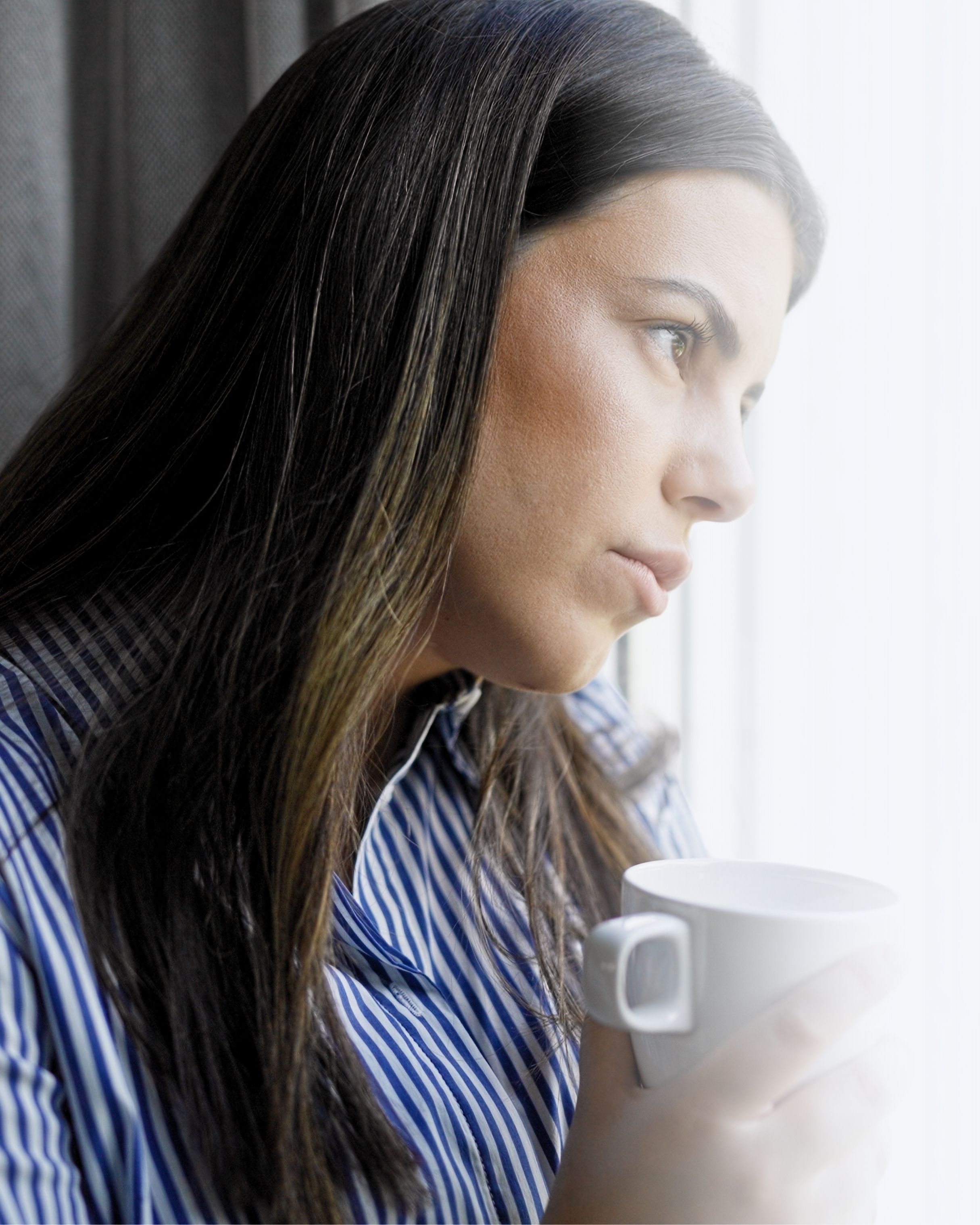 Sad woman looking out window