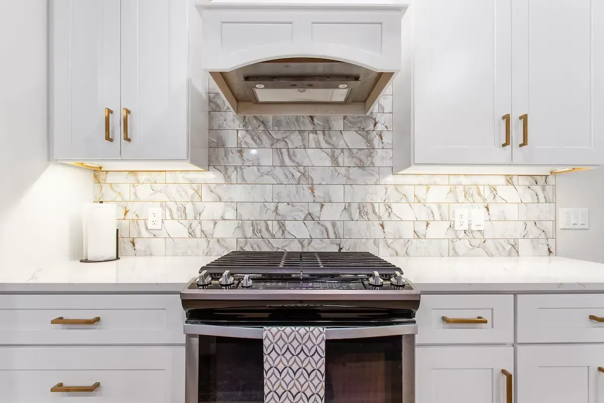 gas range in newly remodeled kitchen with custom cabinets