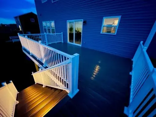 night time photo showing new deck with under step lighting