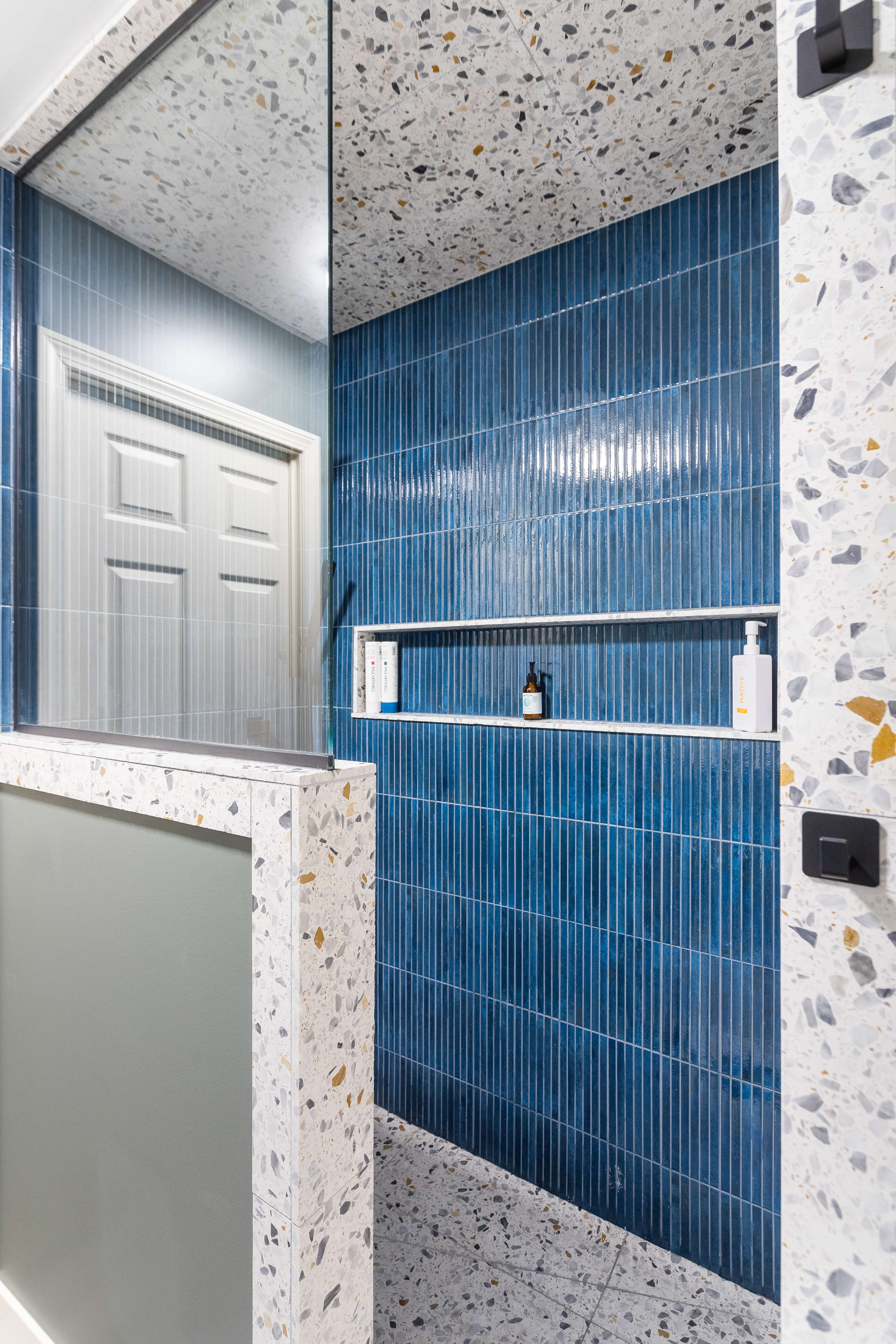 Bathroom shower remodel with blue tile work completed by TPC Construction in Grand Rapids