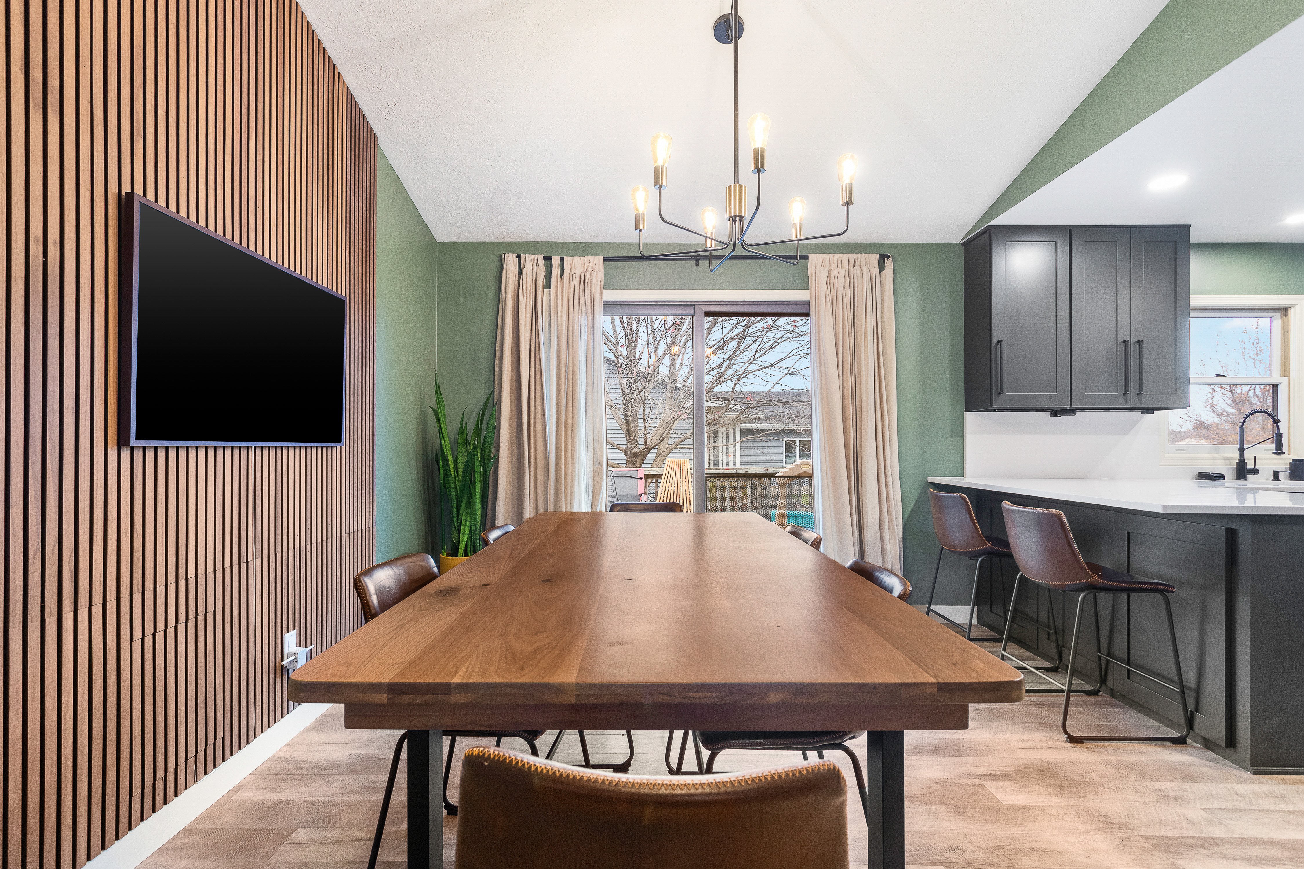 Interior Remodel - dining room with mounted tv and dark cabinet kitchen Grand Rapids
