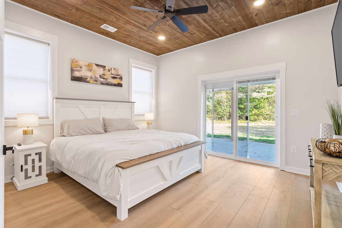 barndo bedroom with sliding door and wood floors