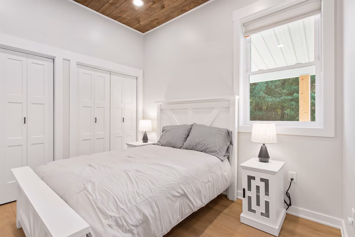 Bedroom constructed in barn with window.