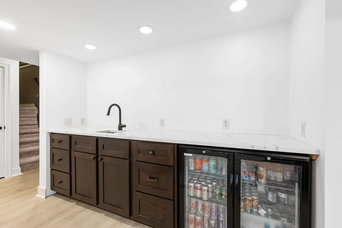 Mini bar with sink and new cabinets for basement finish completed by TPC Construction