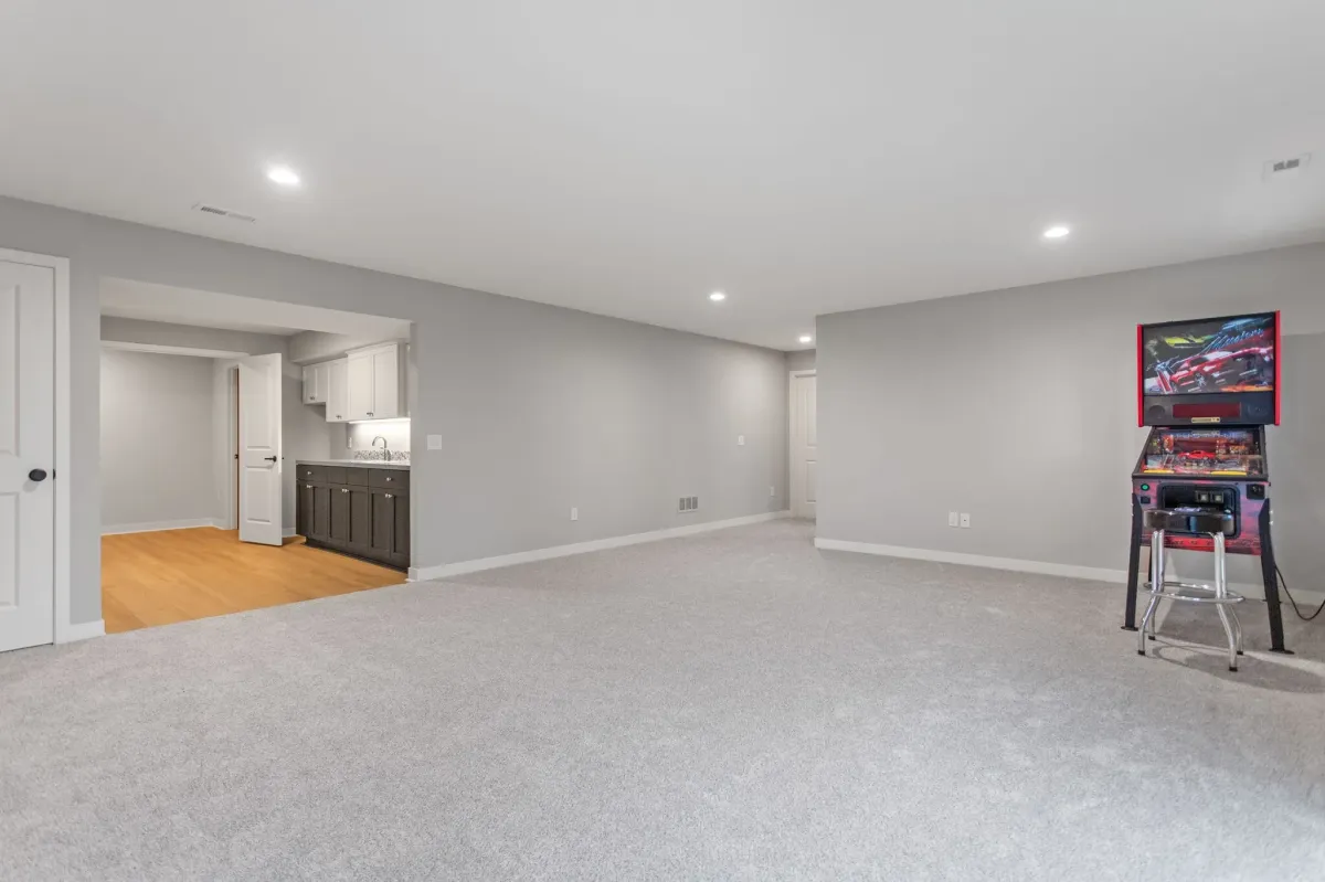 Unfurnished finished basement remodel with pinball machine