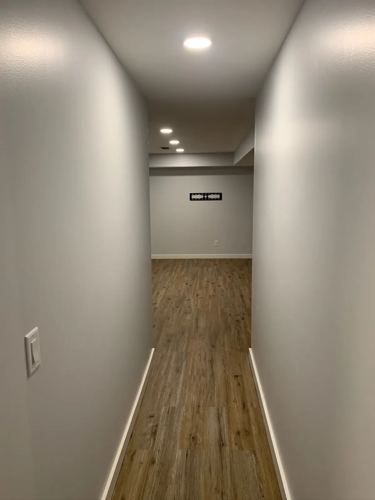 remodeled basement hallway with recessed lighting