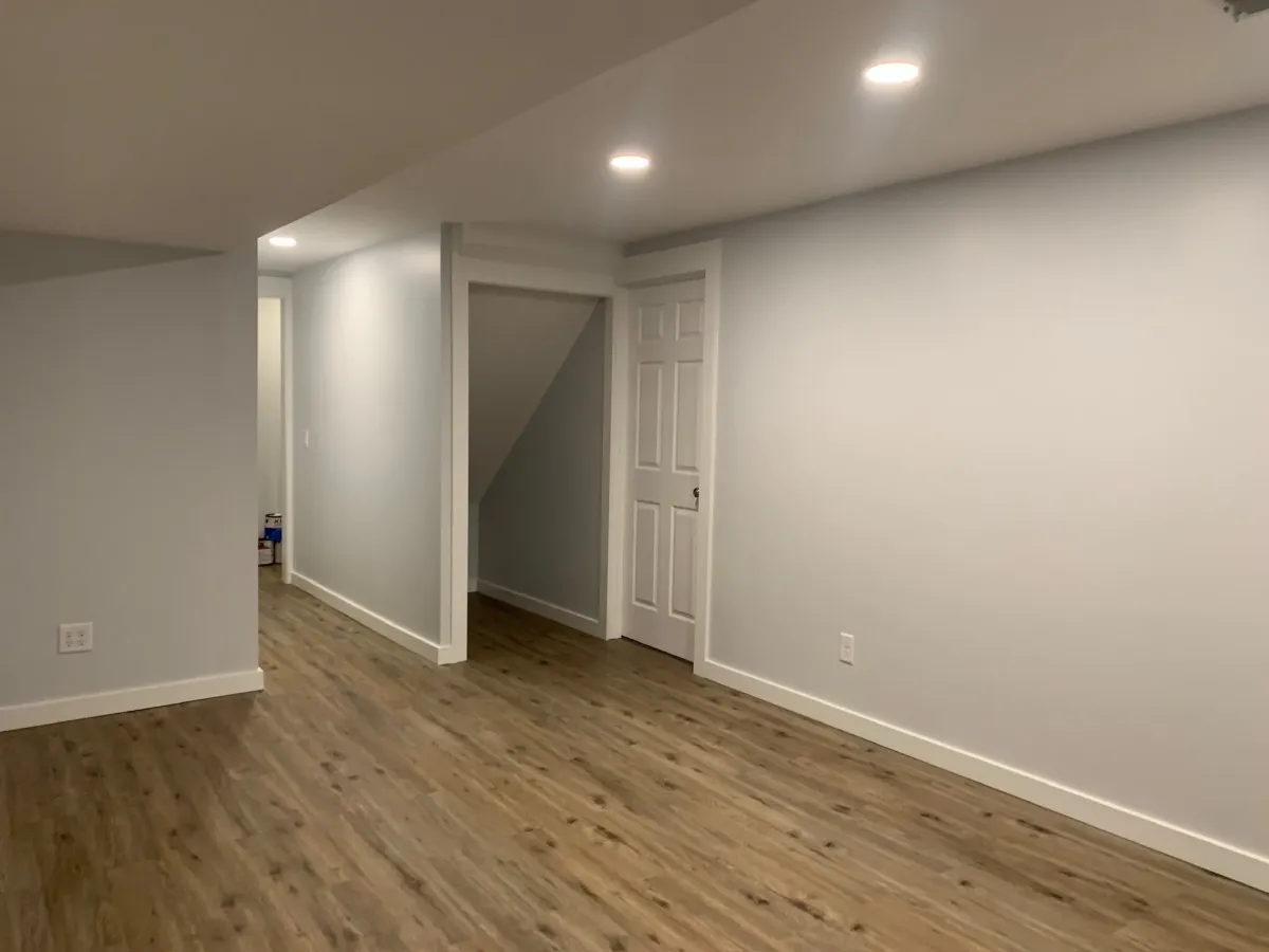 unfurnished basement remodel with under stair storage