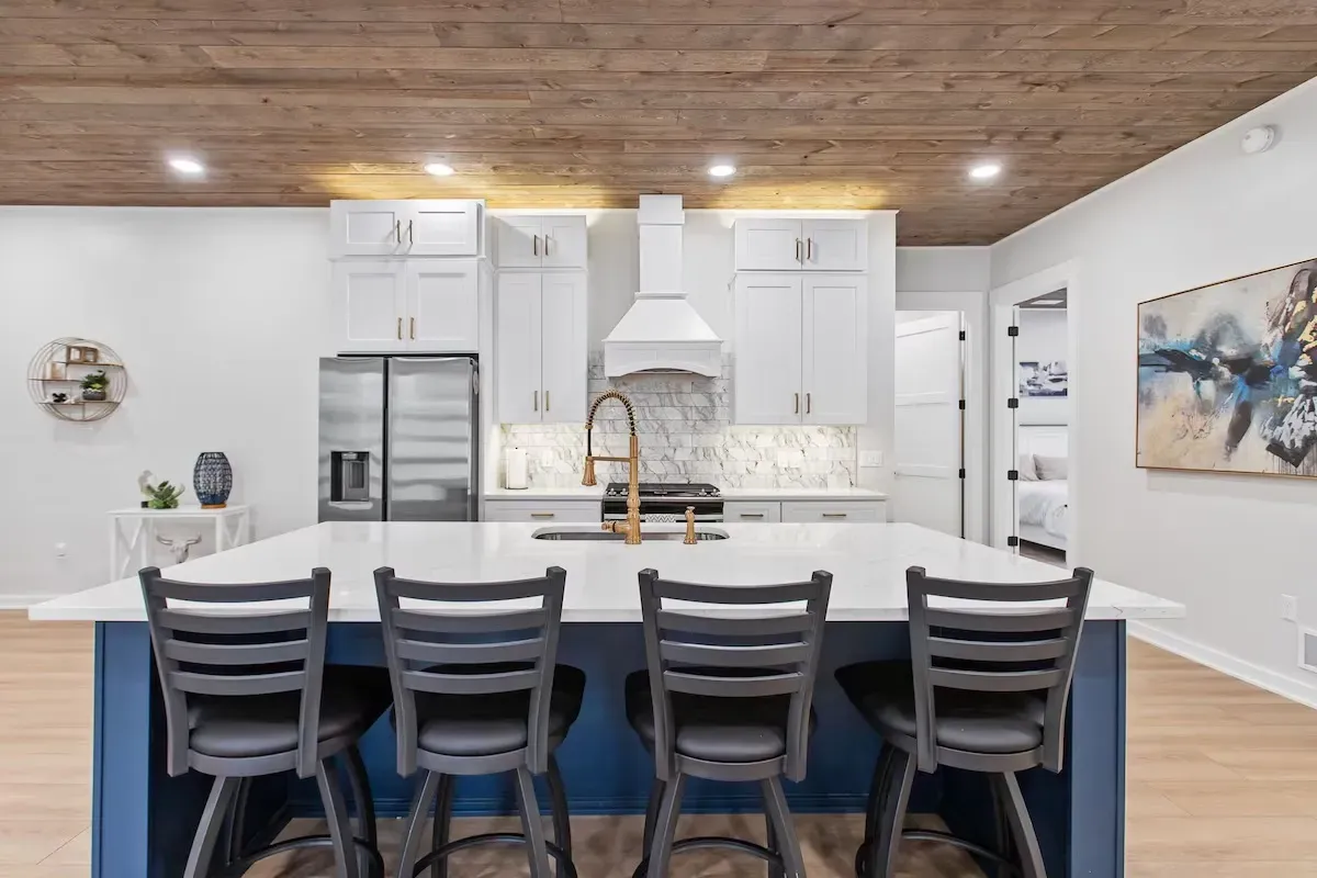 kitchen remodel with island bar seats and modern lighting