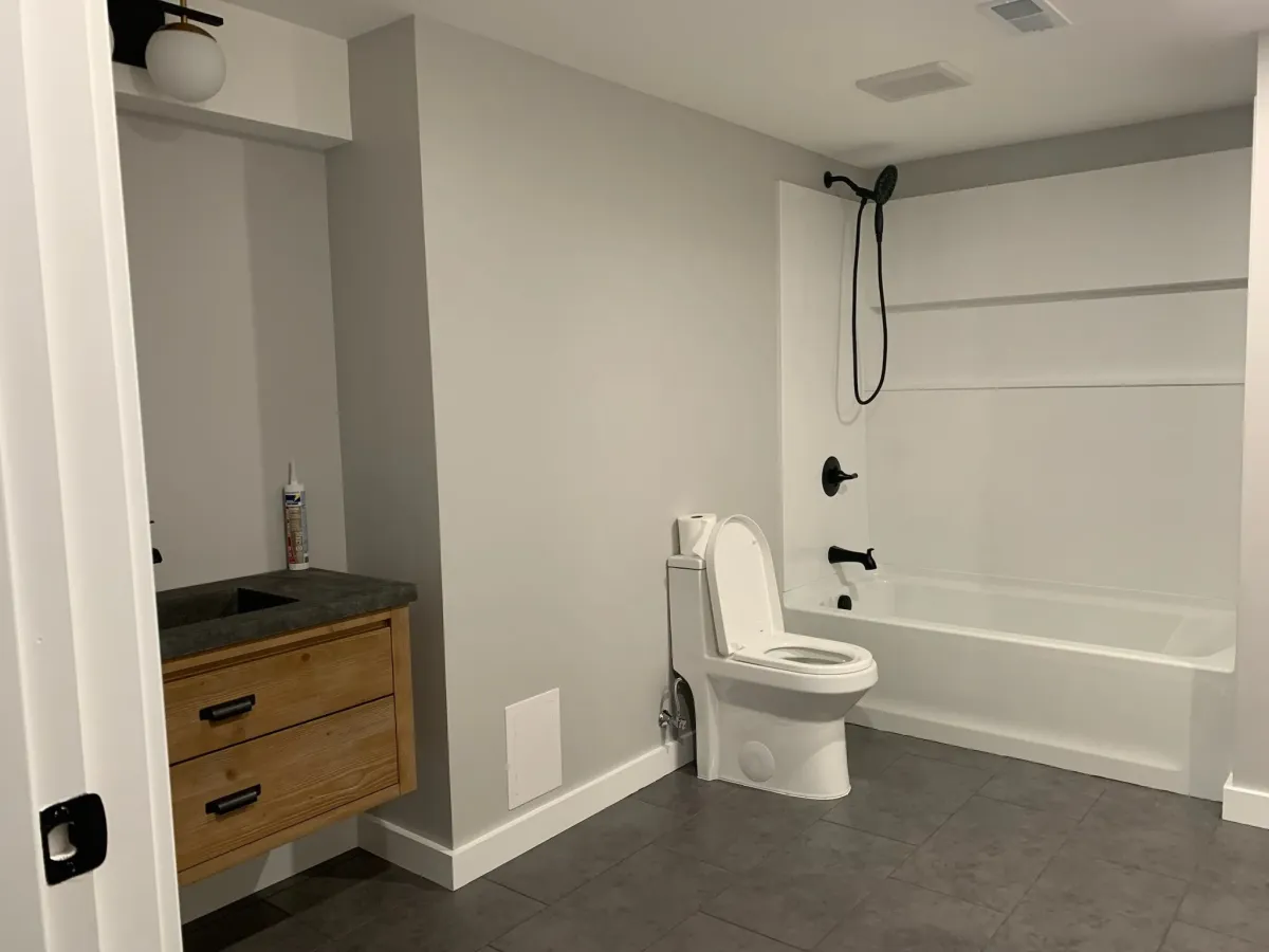 Finished bathroom with new flooring and plumbing