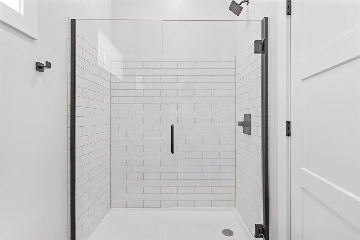 bathroom remodel in grand rapids with glass shower door and white tile