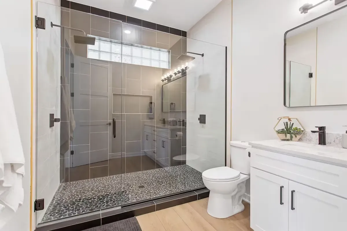 remodeled bathroom with glass shower and custom tile