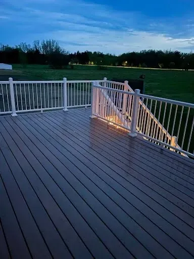 Evening view of newly built deck featuring under-step lighting
