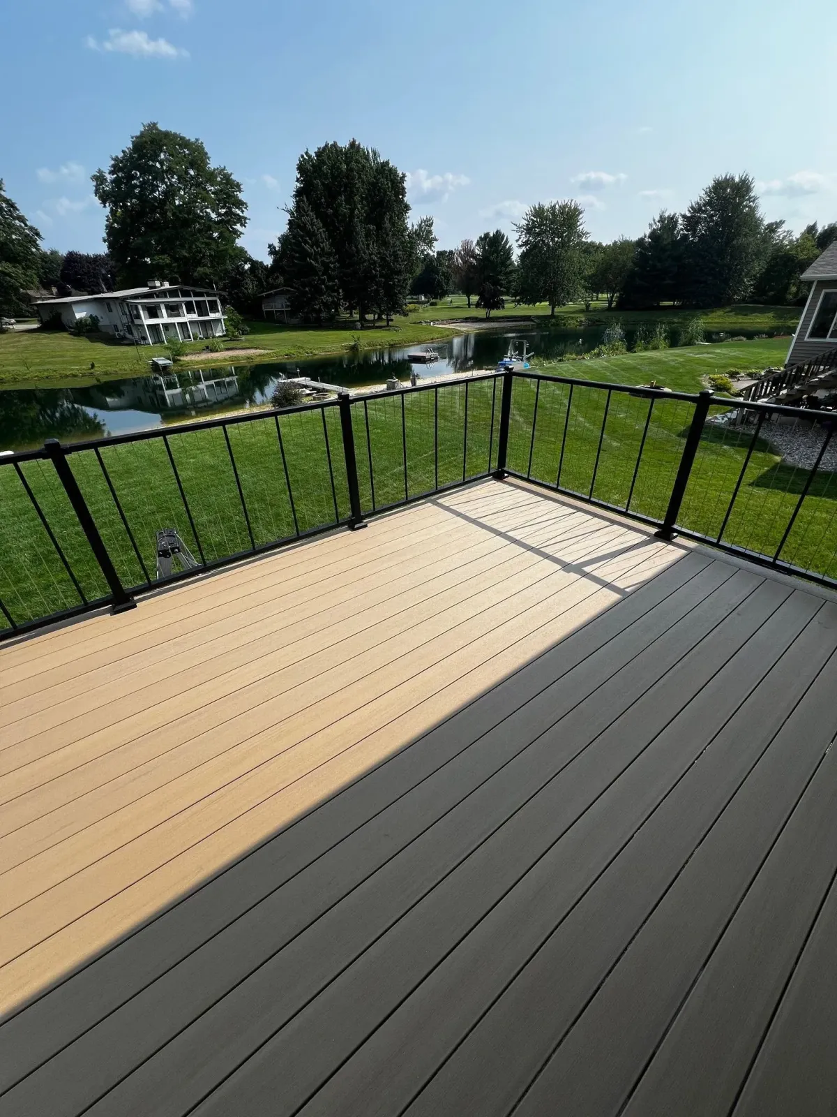 alternate view of newly built deck in grand rapids overlooking a pond