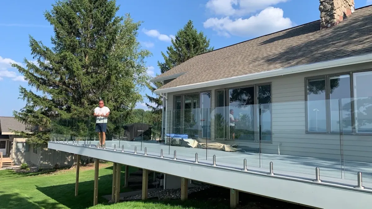 glass railing white plank deck installed on the lakeshore