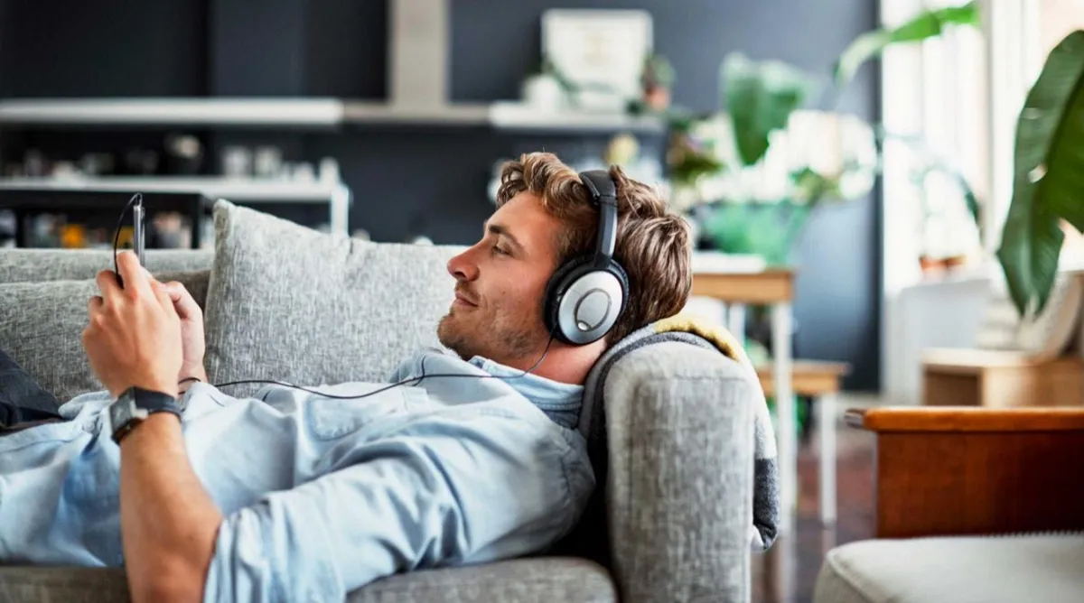 man holding incandescent bulb