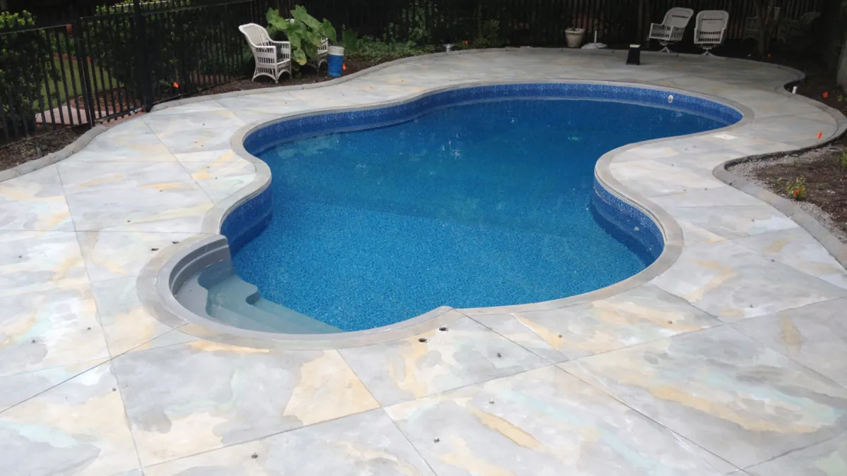 Jackson Concrete Pros levels sidewalk builds and installs pool deck