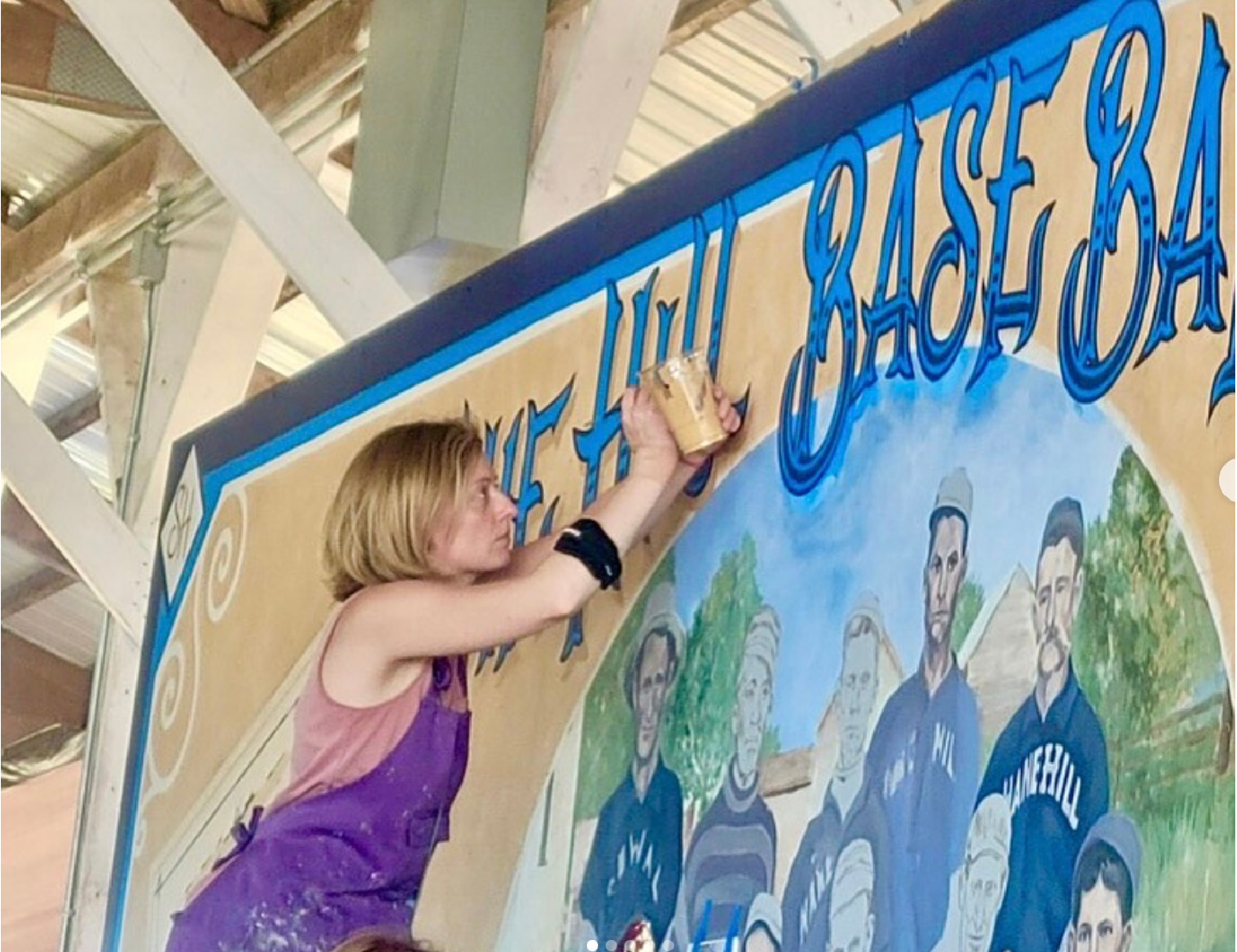 woman painting mural