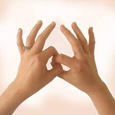 Hands gently practicing self muscle testing in a calm, light space