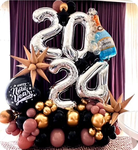 New Year’s or graduation balloon backdrop with metallic numbers and gold accents