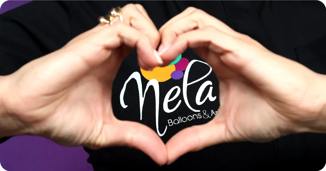 Nela Balloons & Art logo framed with hands in a heart shape