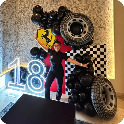Custom racing-themed balloon backdrop for 18th birthday celebration
