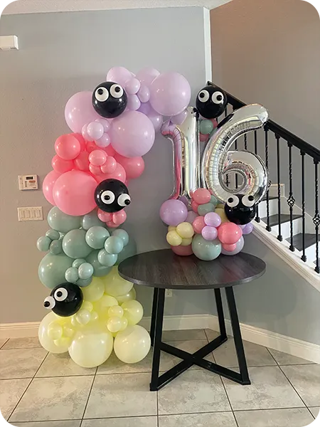 Pastel grab-and-glow balloon garland with panda details – birthday setup