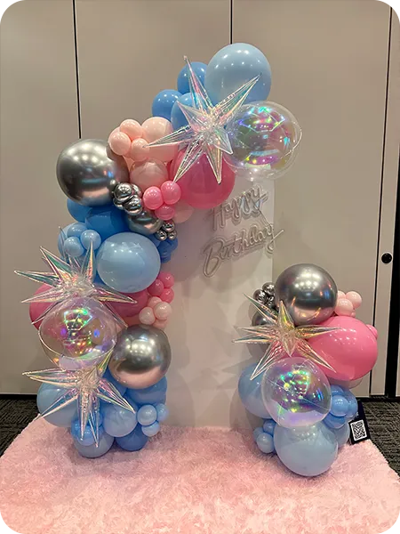 Soft pink and silver balloon installation with neon sign