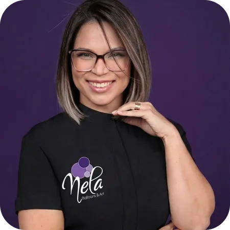 Daniela Duran – Founder of Nela Balloons & Art smiling in branded t-shirt