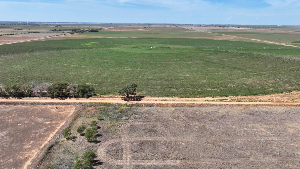 Aerial view of farmland and green crop circles at Natalia Plains near Idalou, owner-financed land for sale near Lubbock, Texas